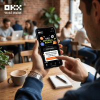 Hand holding smartphone displaying OKX Wallet referral bonus notification with promo code and claim button